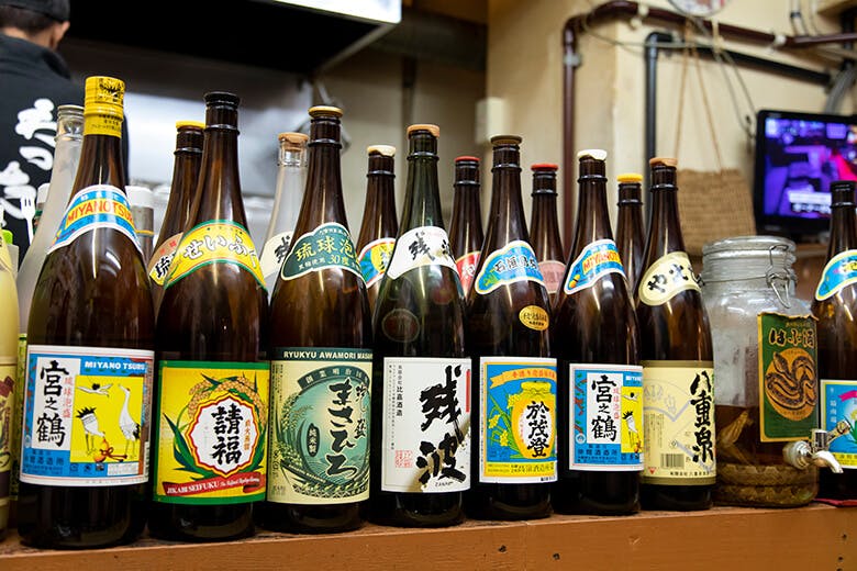 あんつく|カウンターに並ぶ豊富な泡盛の一升瓶