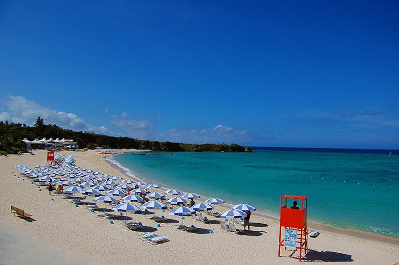 ニライビーチ｜青い海と空に赤い監視台が映えるビーチ全景