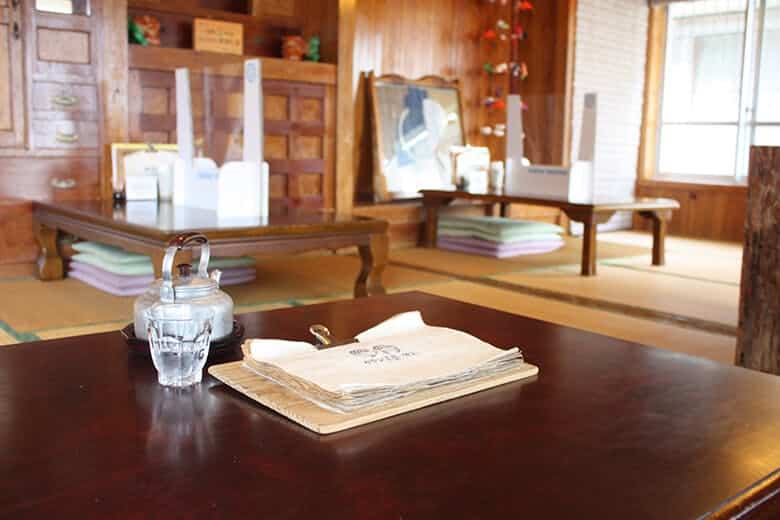 みやび茶屋・仲元｜古民家を活かした店舗内観とテーブルにおかれたメニュー