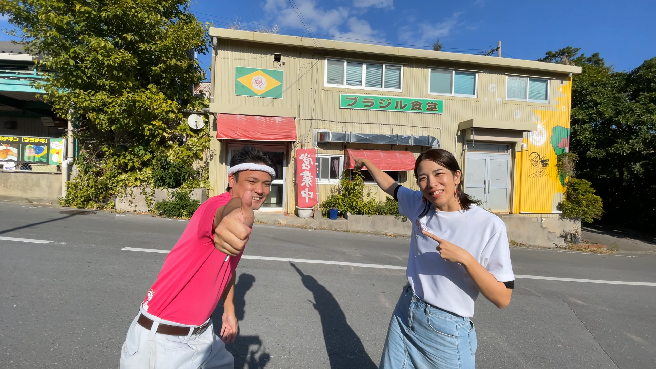 名護市にあるブラジル食堂の外観と、笑顔でレポートを始めるじゅん選手・ひーとーさん